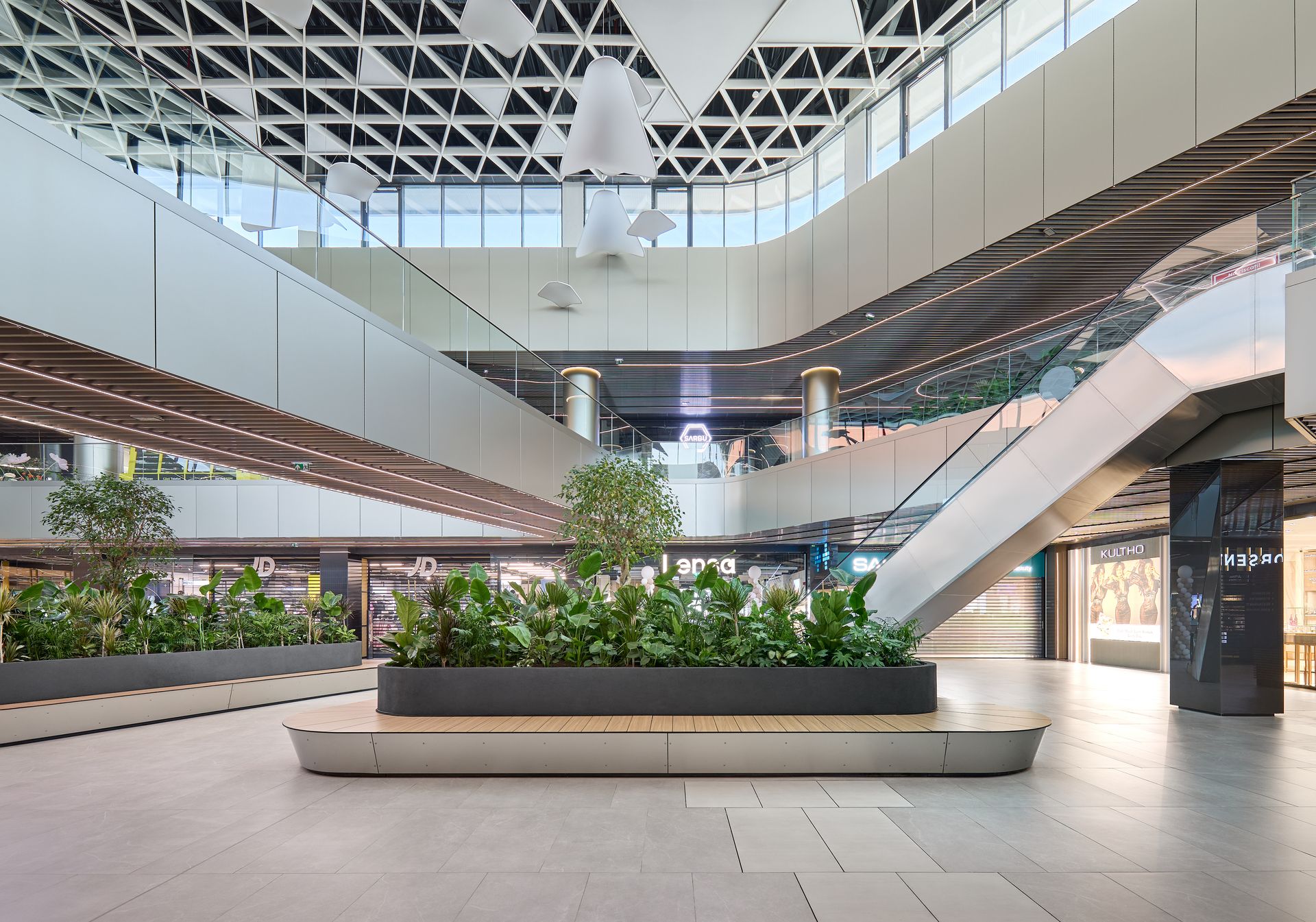 Bright interior atrium with white sculptural ceiling and greenery, Arena Mall Bacău