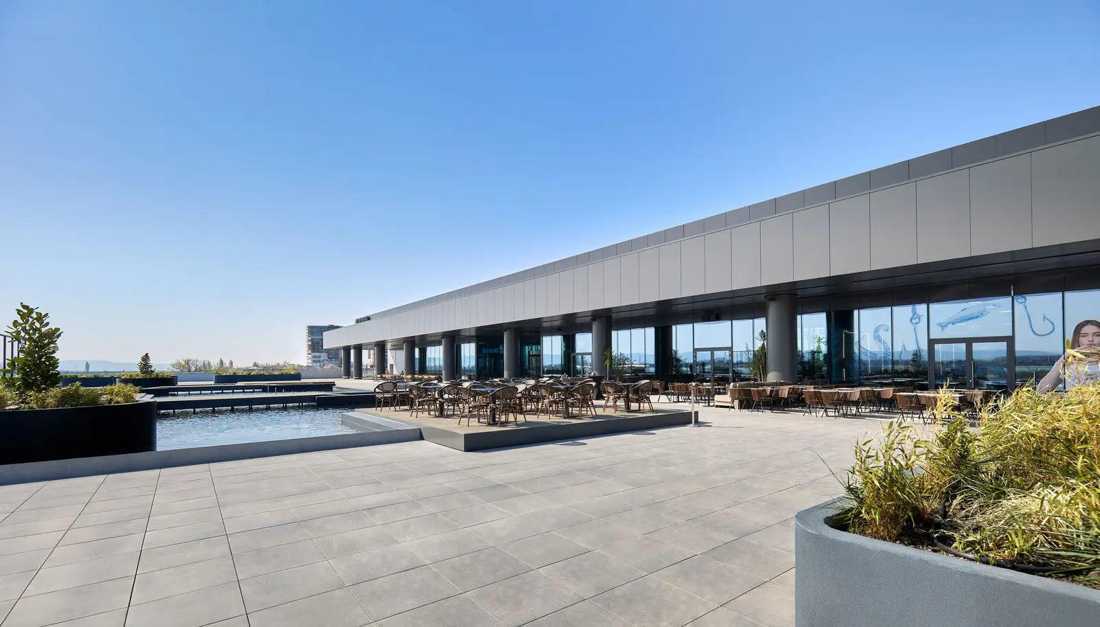 Rooftop outdoor promenade with storefronts, Arena Mall Bacău