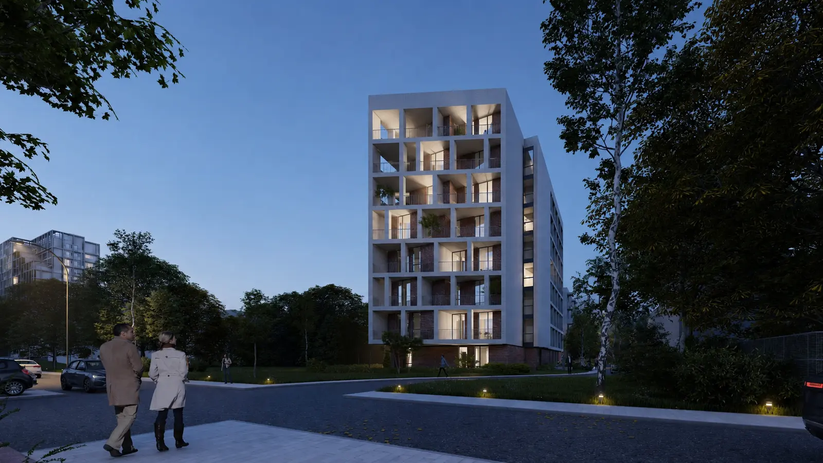 The same view at dusk: the loggias, lit from within, draw out the grid, while discreet lighting marks the approach