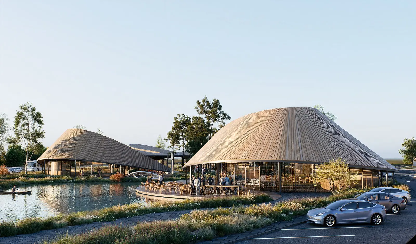 The timber deck terrace at the water's edge, with tables under the wide overhang of the roof